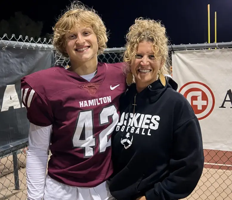 Jackson standing with his mother after a football game