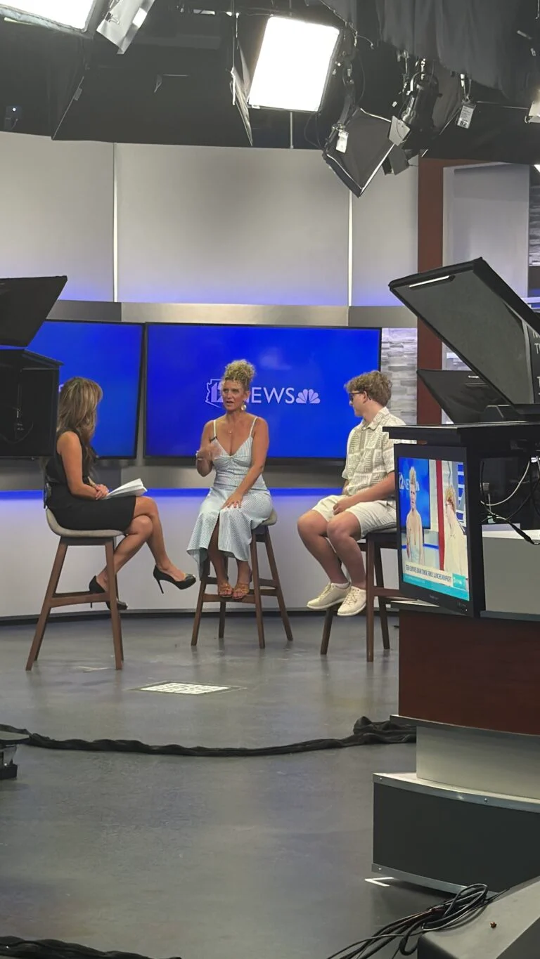 Carebridge representatives seated for an interview inside the 12News studio